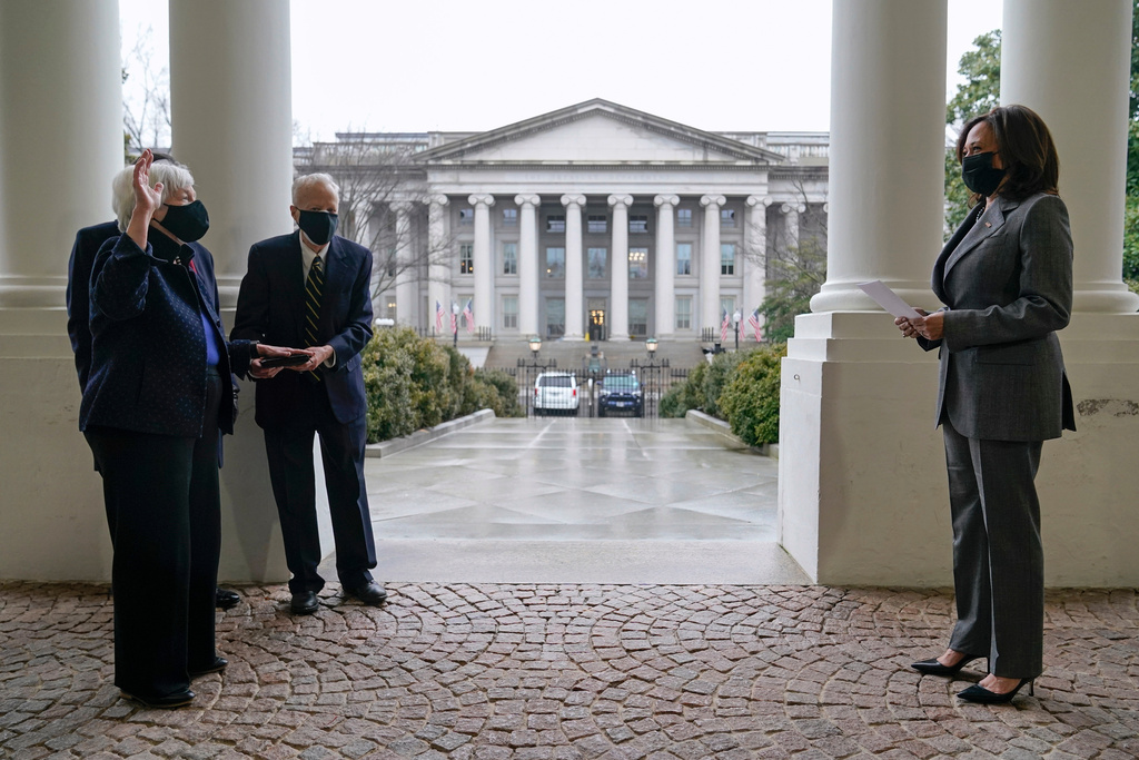 FILE - Vice President Kamala Harris, right, swears in Treasury Secretary Janet Yellen, as Yellen's husband George Akerlof stands by, at the East Wing of the White House in Washington, Jan. 26, 2021, across from the Treasury building. (AP Photo/Patrick Semansky, File)