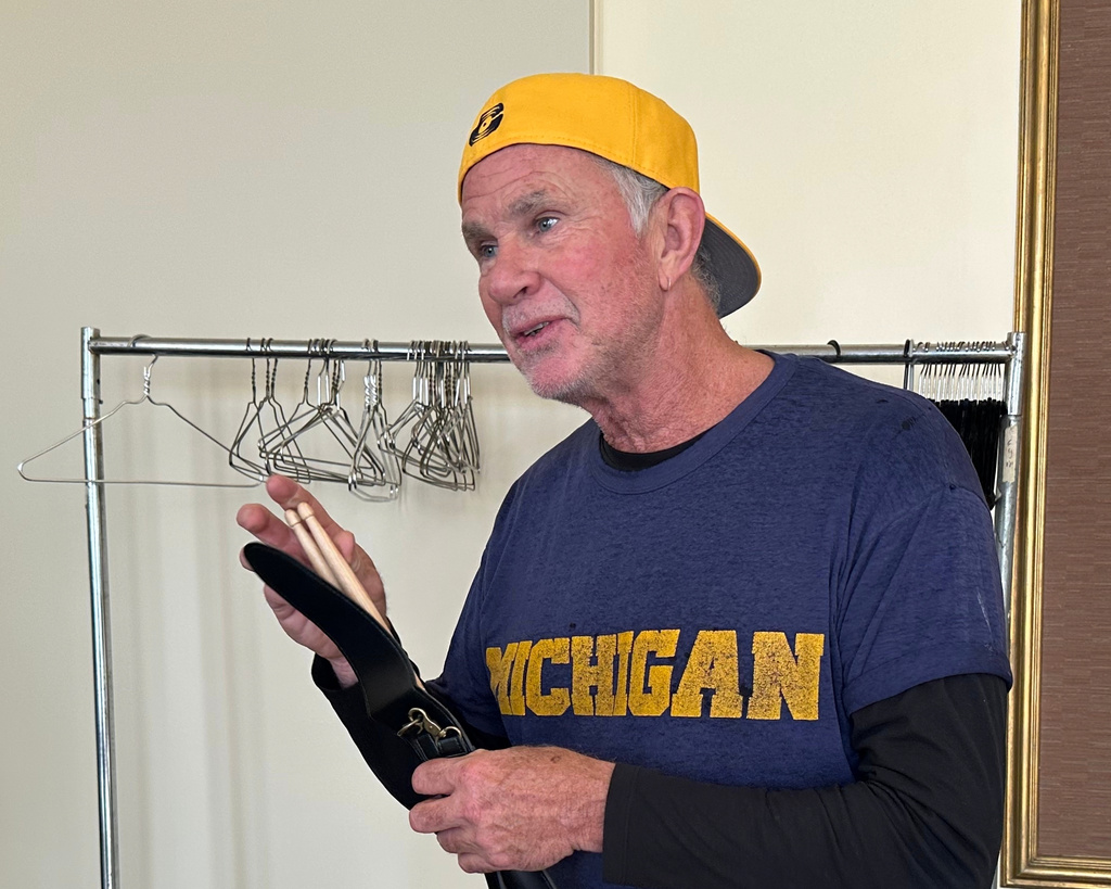 Red Hot Chili Peppers drummer Chad Smith holds a pair of drum sticks in Hill Auditorium on the campus of the University of Michigan Sunday, Nov. 2, 2025, in Ann Arbor, Mich. (AP Photo/Mike Householder)