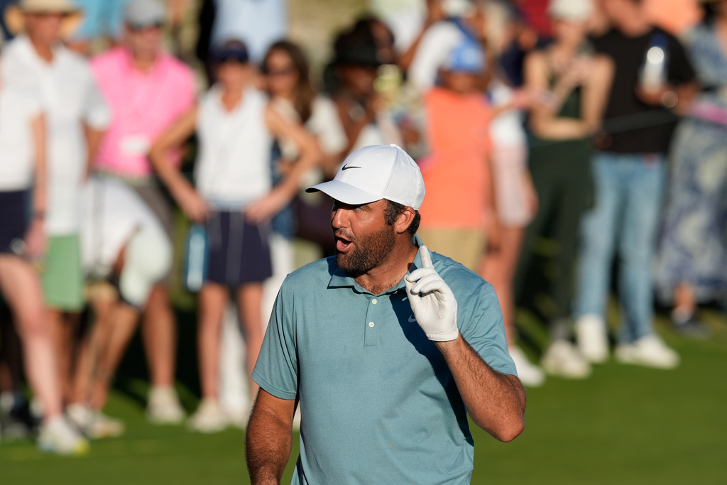 Scottie Scheffler, of the United States, reacts after his shot on 18th green during the third round of the Hero World Challenge PGA Tour at Albany Golf Club in New Providence, Bahamas, Saturday, Dec. 6, 2025. (AP Photo/Fernando Llano)