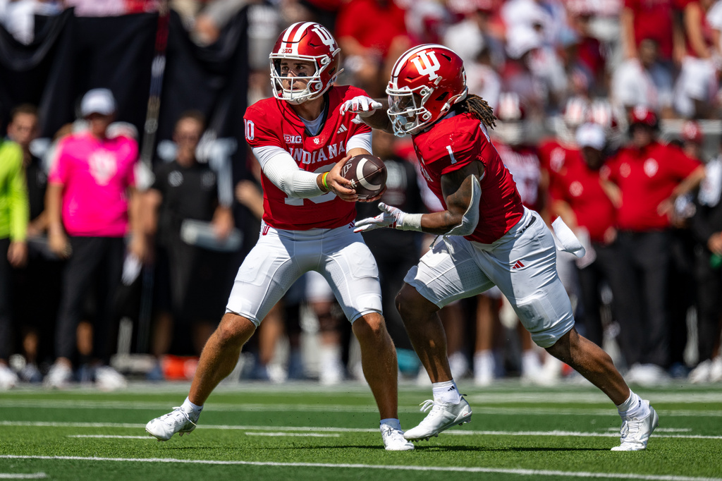 Indiana quarterback Josh Hoover (10) hands off to running back Turbo Richard (1) during the first half of an NCAA college football game against North Texas, Saturday, Sept. 5, 2026, in Bloomington, Ind. (AP Photo/Doug McSchooler)