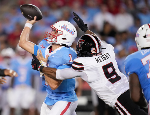 Houston quarterback Conner Weigman (1) is pressured by Texas Tech defensive end Romello Height (9) as he attempted to pass the ball during the first half of an NCAA college football game, Saturday, Oct. 4, 2025, in Houston. (AP Photo/Karen Warren) Houston quarterback Conner Weigman (1) is pressured by Texas Tech defensive end Romello Height (9) as he attempted to pass the ball during the first half of an NCAA college football game, Saturday, Oct. 4, 2025, in Houston. (AP Photo/Karen Warren)