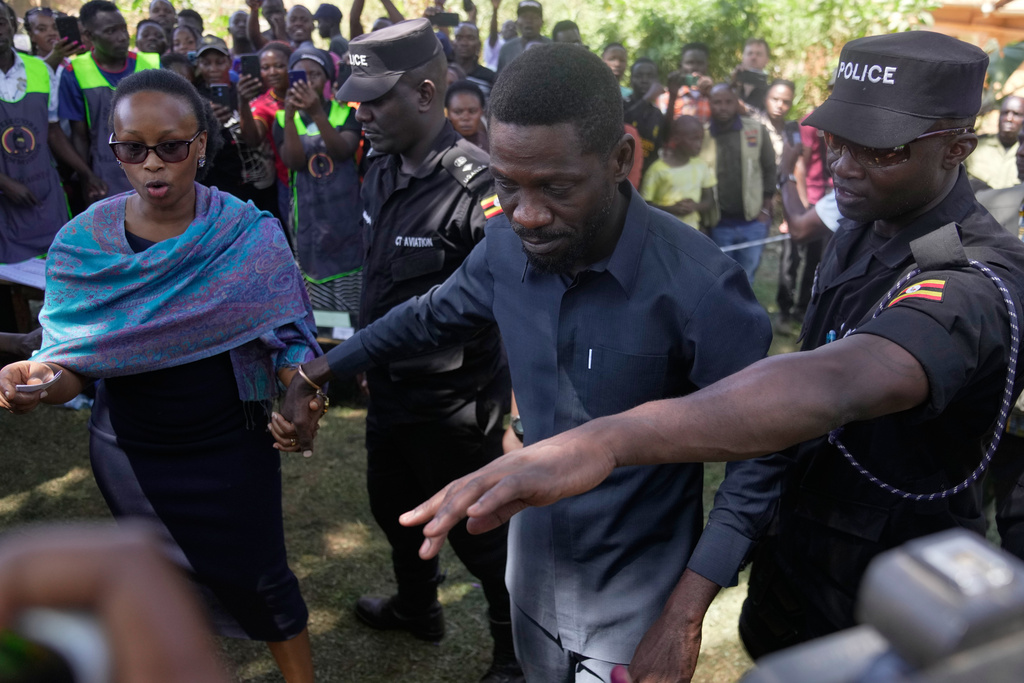 Uganda opposition presidential candidate Robert Kyagulanyi Ssentamu, famously known as Bobi Wine of the National Unity Platform (NUP), arrives with his wife to cast their votes, during the presidential election at a polling station, in Kampala, Uganda, Thursday, Jan. 15, 2026. (AP Photo/Brian Inganga)
