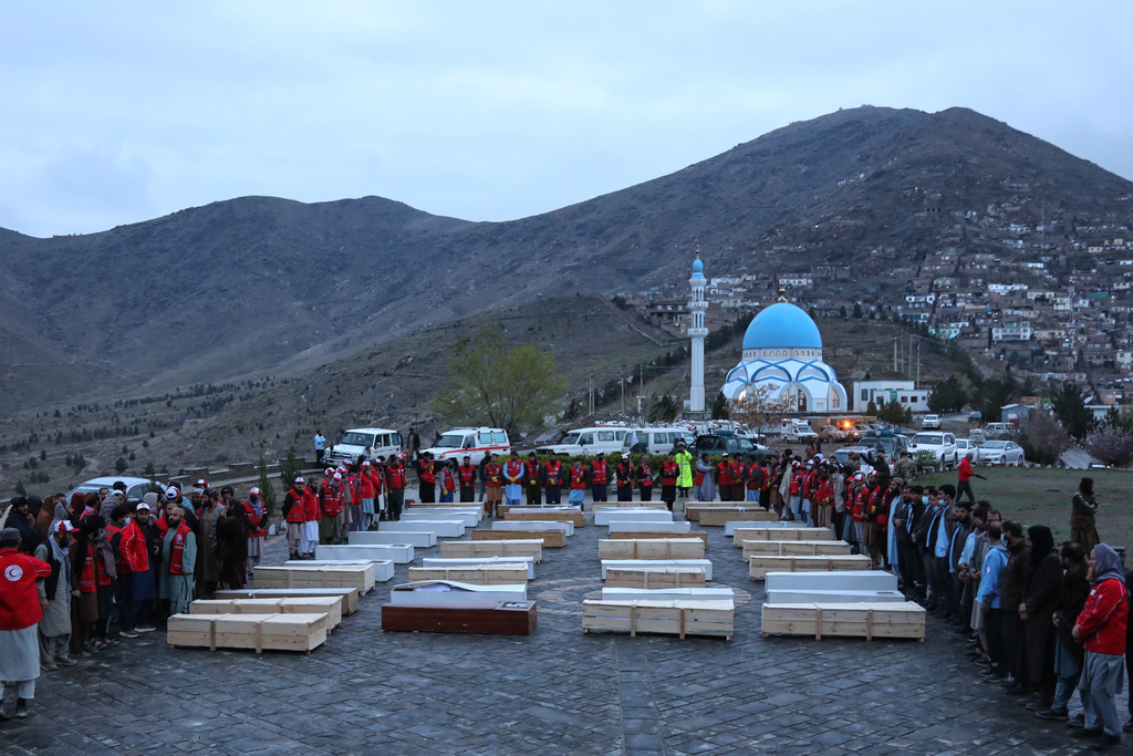 Coffins containing the remains of victims of a Monday airstrike on a drug rehabilitation hospital are laid out before burial in Kabul, Afghanistan, Wednesday, March 18, 2026. (AP Photo/Siddiqullah Alizai)
