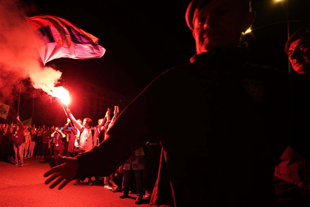People welcome a group of students from southwestern town of Novi Pazar after marching to join a major rally marking the anniversary of a deadly train station disaster, in Novi Sad, Serbia, Friday, Oct. 31, 2025. (AP Photo/Darko Vojinovic)