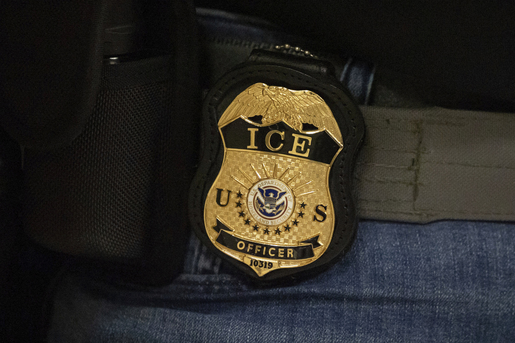 FILE - A federal agent wears an Immigration and Customs Enforcement badge in New York, June 10, 2025. (AP Photo/Yuki Iwamura, File)