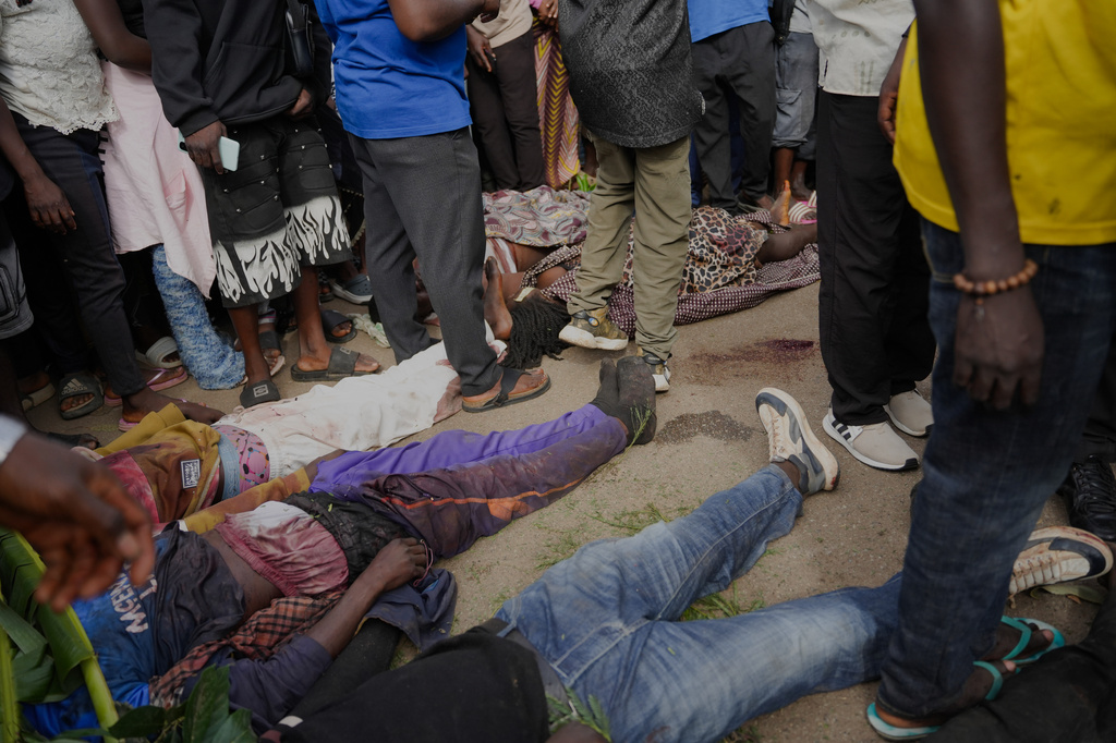 People gather around bodies of a gunmen attack victims in Gari Ya Waye community in Jos North Nigeria, Monday, March 30, 2026. (AP Photo/Samson Omale)