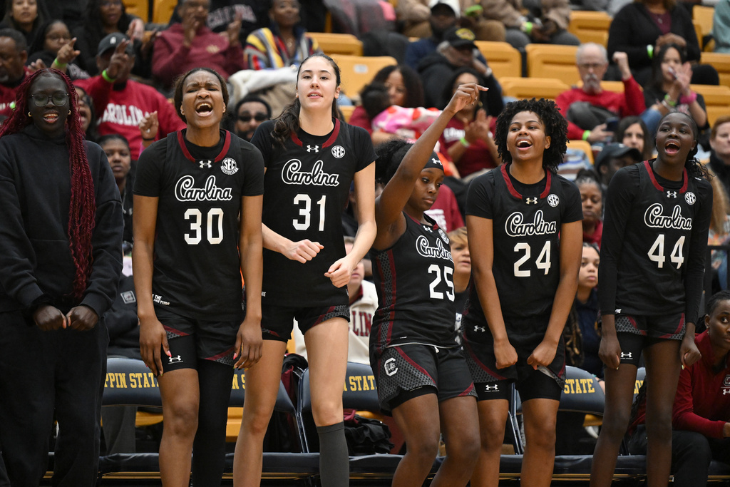 The South Carolina bench cheers after a 3-point basket against Coppin State during the second half of an NCAA college basketball game Sunday, Jan. 18, 2026, in Baltimore. (AP Photo/Gail Burton)