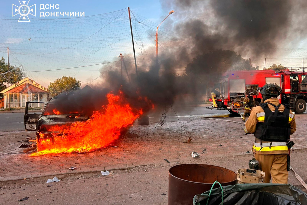 In this photo provided by the Ukrainian Emergency Service, emergency services personnel work to extinguish a fire after Russia's air attack in Druzhkivka, Donetsk region, Ukraine, Wednesday, June 24, 2026. (Ukrainian Emergency Service via AP)