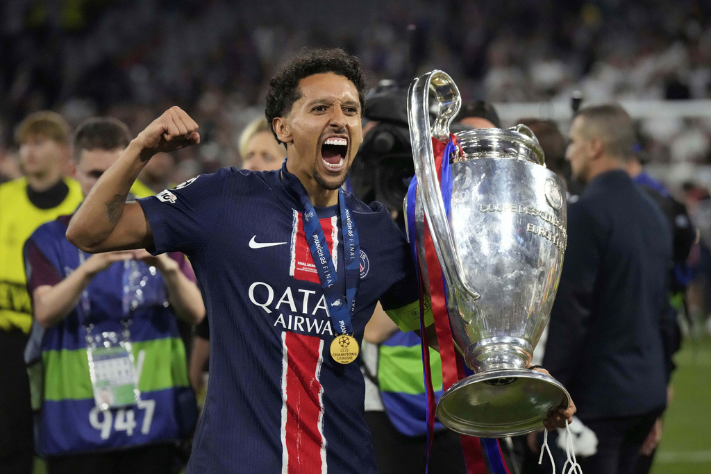 FILE - PSG's Marquinhos poses with the trophy after the Champions League final soccer match between Paris Saint-Germain and Inter Milan at the Allianz Arena in Munich, Germany, May 31, 2025. (AP Photo/Matthias Schrader, file)