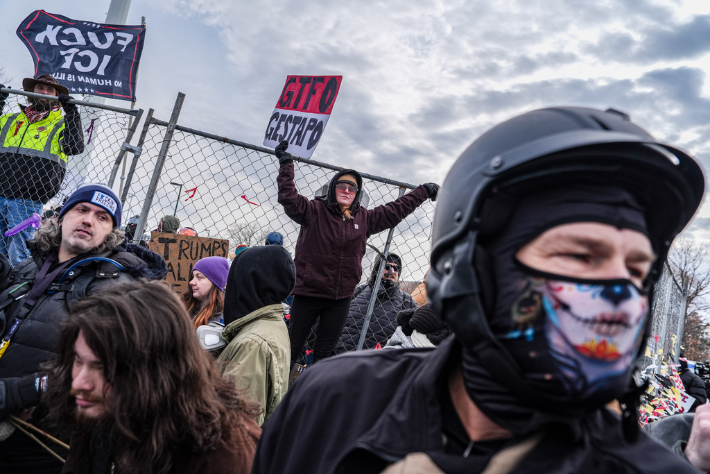 People attend an anti-ICE protest outside the Bishop Whipple Federal building in Minneapolis, Saturday, Feb. 7, 2026. (AP Photo/Ryan Murphy)
