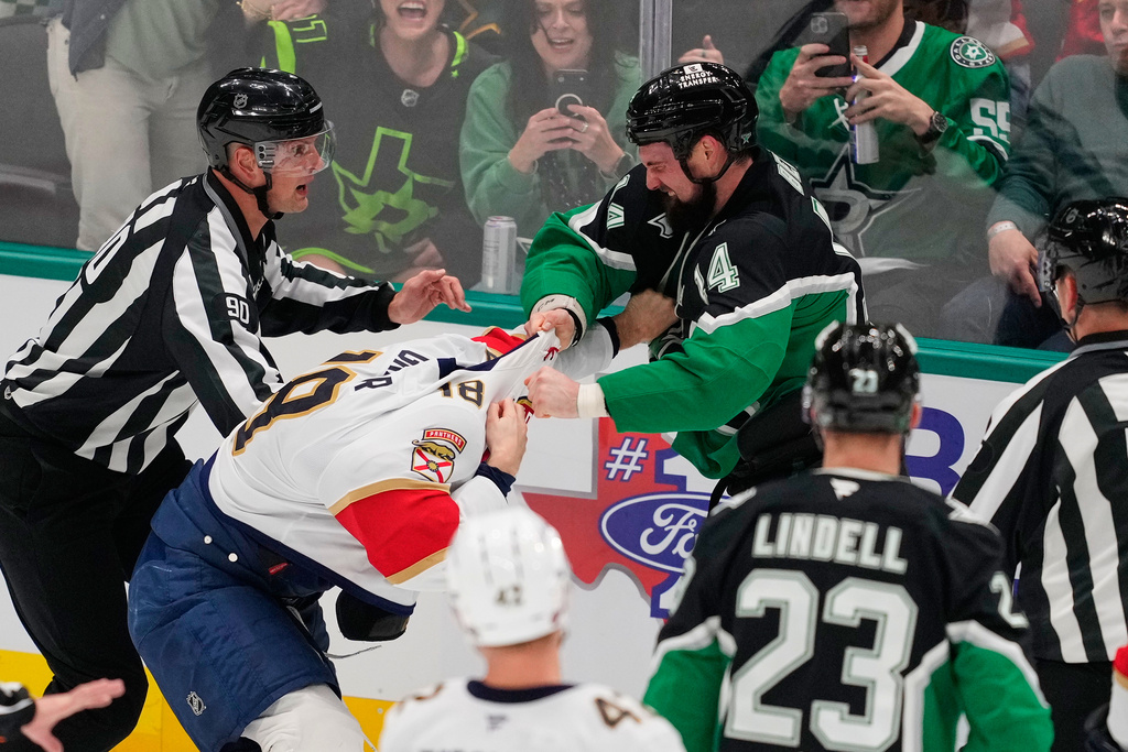 Dallas Stars left wing Jamie Benn (14) delivers a punch to Florida Panthers' Noah Gregor (18) as the two fight in the second period of an NHL hockey game in Dallas, Saturday, Dec. 13, 2025. (AP Photo/Tony Gutierrez)