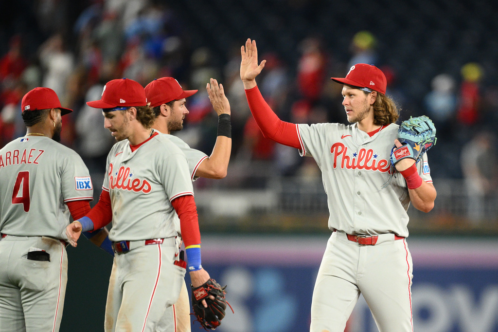 Philadelphia Phillies' Alec Bohm, right, and teammates celebrate after a baseball game against the Washington Nationals, Wednesday, Sept. 16, 2026, in Washington. (AP Photo/Nick Wass)