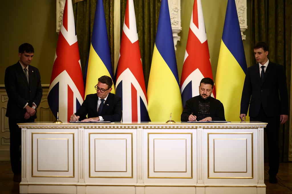 Ukraine's President Volodymyr Zelenskyy and Britain's Prime Minister Andy Burnham sign a partnership deal on AI following a bilateral meeting at Horodetskyi House in Kyiv, Monday, Aug. 24, 2026. (Henry Nicholls/Pool Photo via AP)