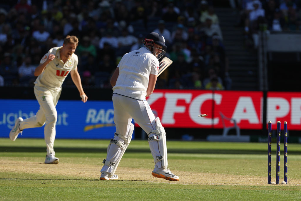 Australia's Cameron Green, left, celebrates after bowling England's Gus Atkinson, right, during their Ashes cricket test match in Melbourne, Friday, Dec. 26, 2025. (AP Photo/Hamish Blair)