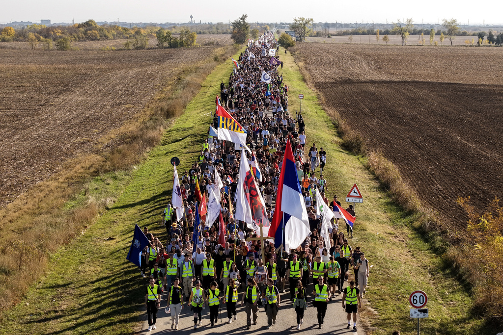 An aerial view of students marching through the fields in northern Serbia, as they go to Novi Sad for a huge rally on Nov. 1 marking the first anniversary of a train station disaster that killed 16 people, in Indjija, Serbia, Friday, Oct. 31, 2025. (AP Photo/Armin Durgut)