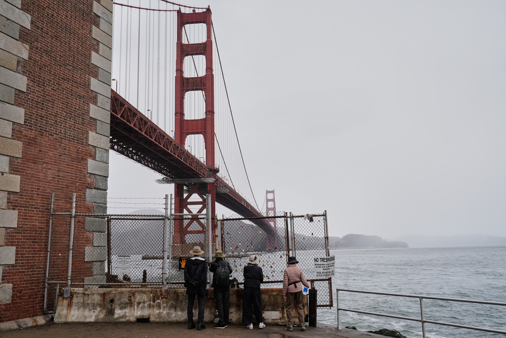 People look at the Golden Gate Bridge outside the Fort Point National Historic Site, which is closed due to a government shutdown, Wednesday, Oct. 1, 2025, in San Francisco. (AP Photo/Godofredo A. Vásquez)