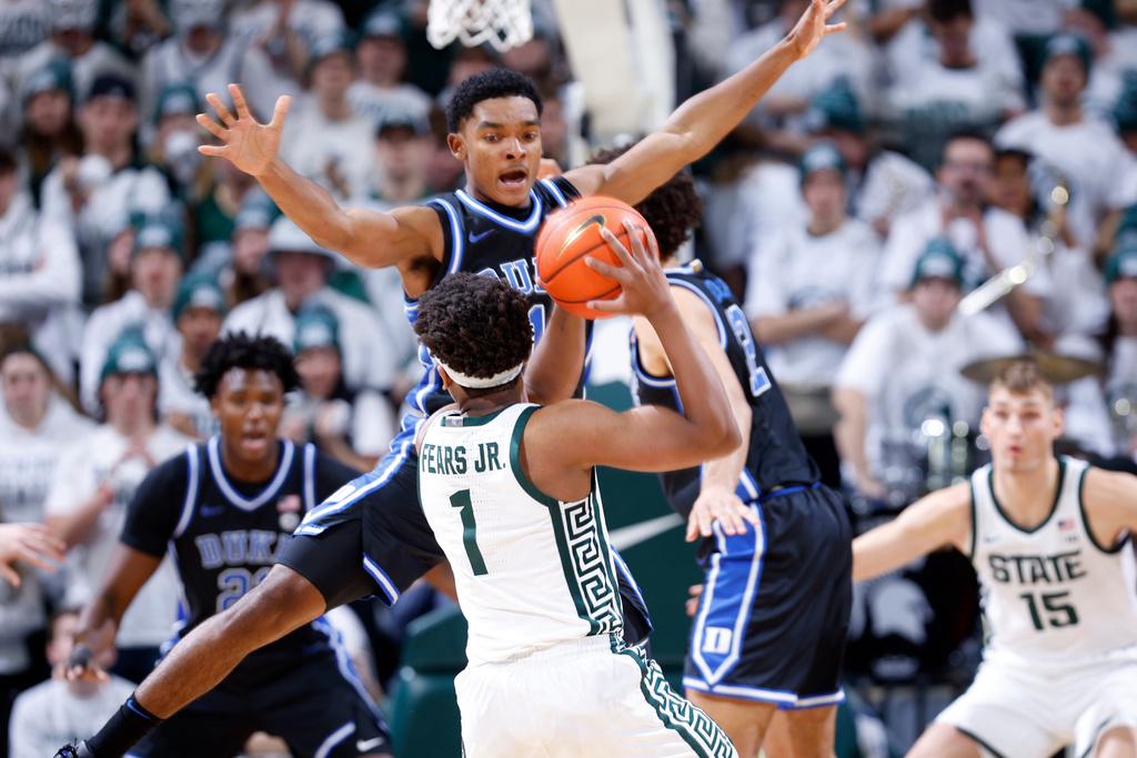 Duke guard Caleb Foster, rear, pressures Michigan State guard Jeremy Fears Jr. (1) during the first half of an NCAA college basketball game, Saturday, Dec. 6, 2025, in East Lansing, Mich. (AP Photo/Al Goldis)