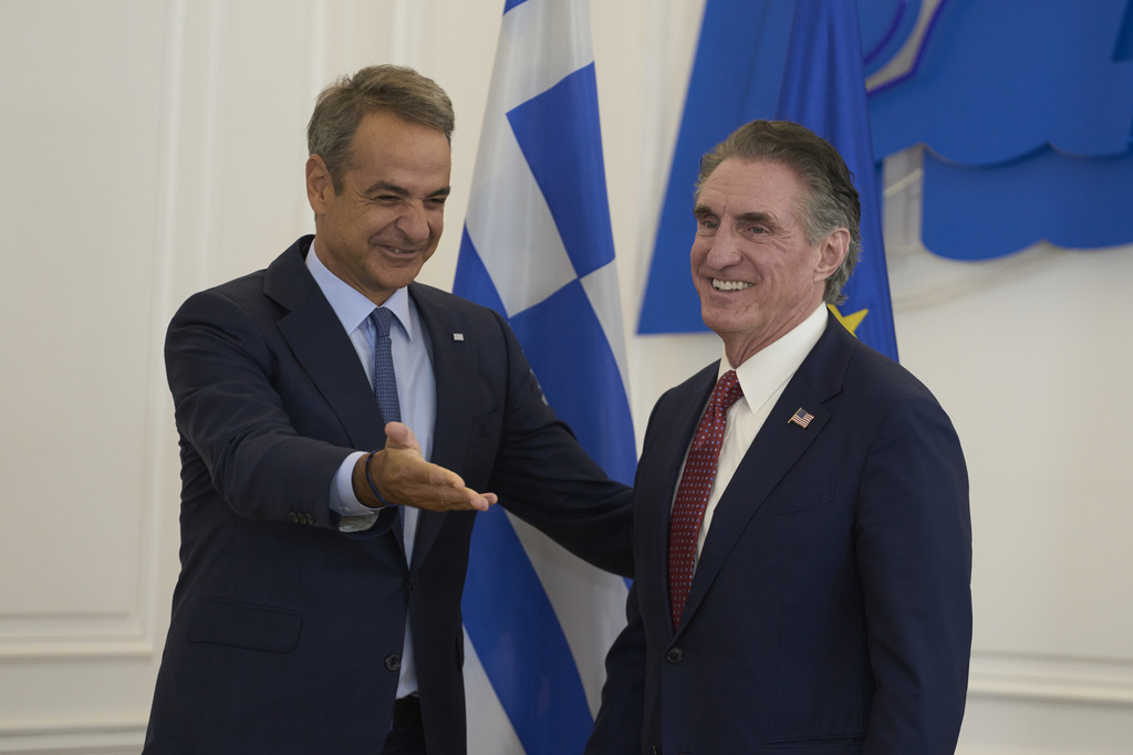 Greek Prime Minister Kyriakos Mitsotakis, left, shows the way to U.S. Secretary of the Interior Doug Burgum, during their meeting at the Maximou Mansion in Athens, Thursday, Sept. 11, 2025. (AP Photo/Petros Giannakouris)