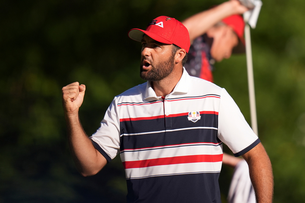 United States' Scottie Scheffler celebrates after a putt on the 18th hole during their singles match on the Bethpage Black golf course at the Ryder Cup golf tournament, Sunday, Sept. 28, 2025, in Farmingdale, N.Y. (AP Photo/Seth Wenig)