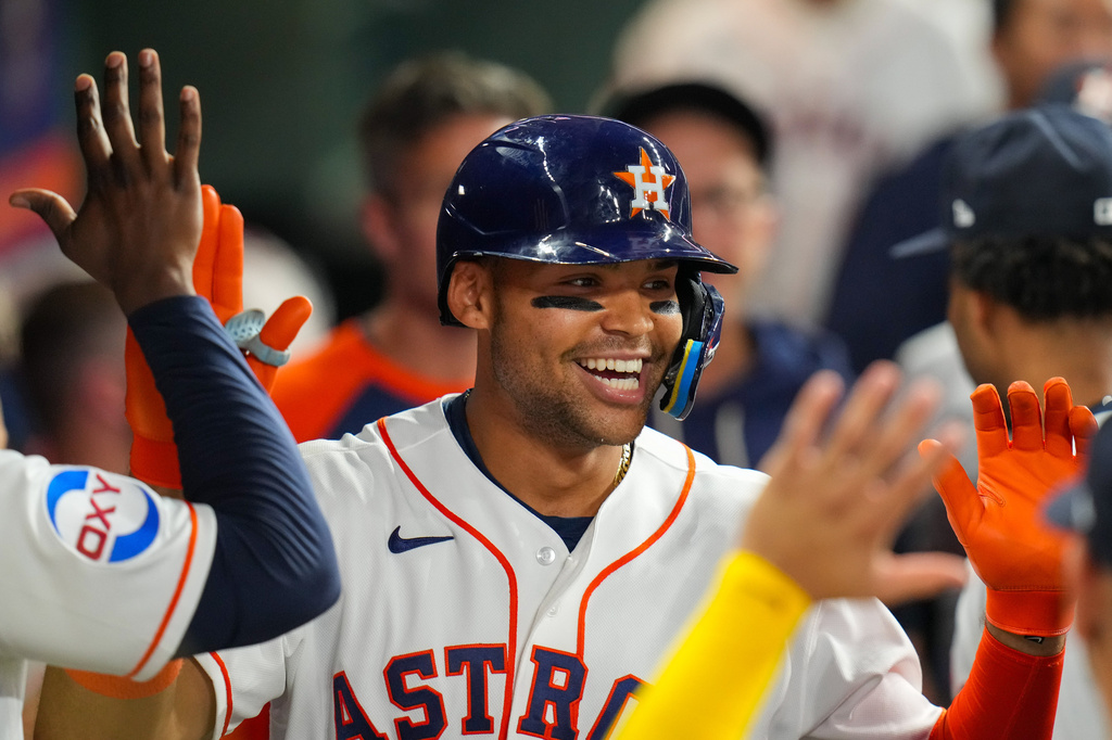 Houston Astros' Cam Smith celebrates with teammates in the dugout after he hit a home run during the seventh inning of a baseball game in Houston, Tuesday, March 31, 2026. (AP Photo/Jon Shapley)
