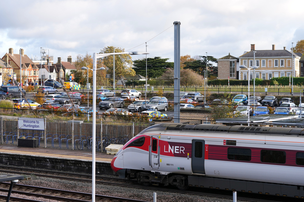 A train is stopped at a railway station after a mass stabbing on a London-bound train in Huntingdon, England, Sunday, Nov. 2, 2025.(AP Photo/Kirsty Wigglesworth)