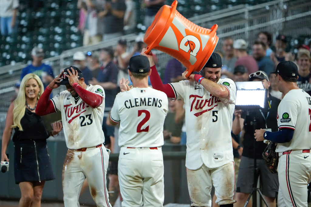 Minnesota Twins' Ryan Kreidler (5) takes a bucket of Gatorade off his head after he and Royce Lewis, second from left, were doused after Lewis' hit an RBI triple walk-off scoring Victor Caratini and Brooks Lee in the ninth inning of a baseball game against the Kansas City Royals, Tuesday, July 28, 2026, in Minneapolis. (AP Photo/Joseph Scheller)