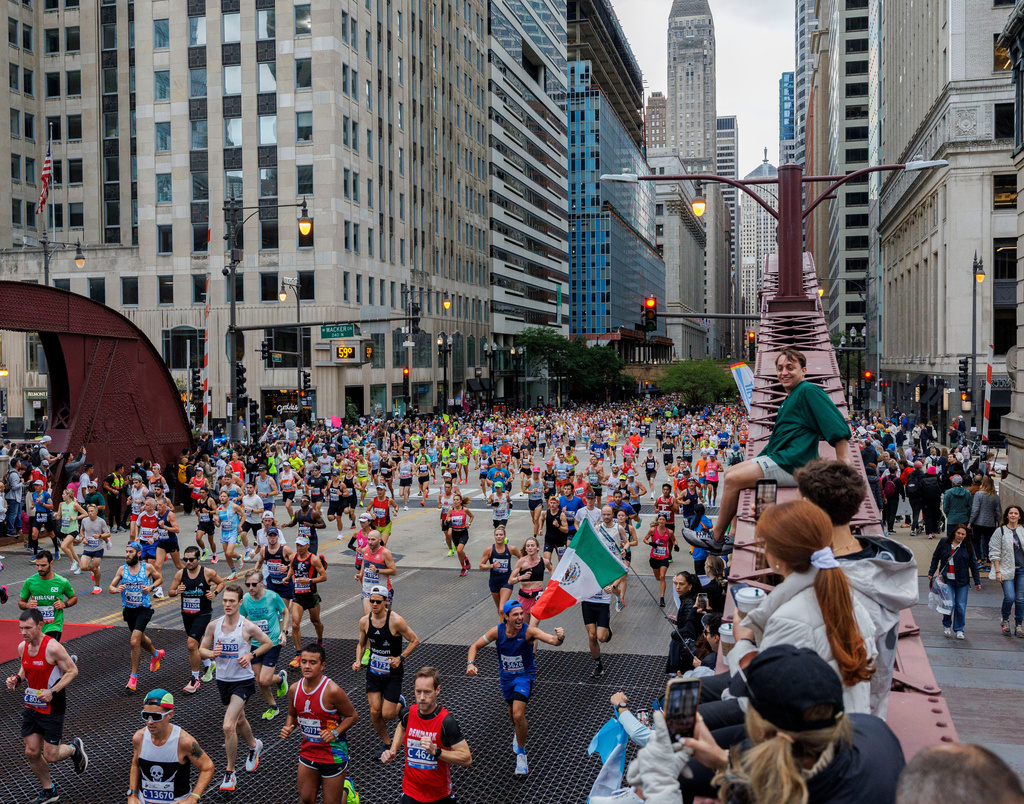 FILE - Runners cross the LaSalle Street bridge during the Chicago Marathon, Sunday, Oct. 13, 2024, in Chicago. (Armando L. Sanchez/Chicago Tribune via AP, File)