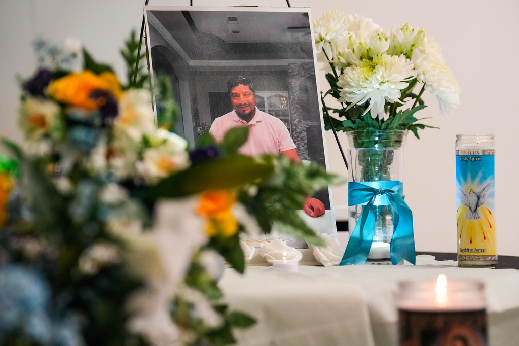 A photograph of Lorenzo Salgado Araujo is displayed on an altar surrounded by candles during a community vigil in Houston on Saturday, July 11, 2026. (Raquel Natalicchio/Houston Chronicle via AP)