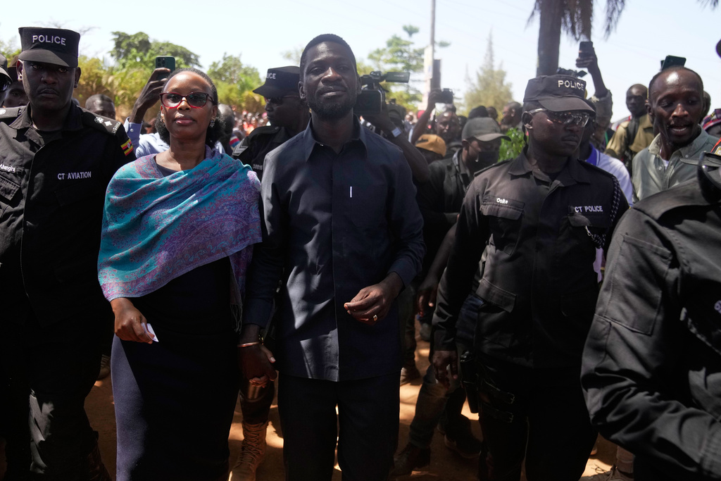 Uganda opposition presidential candidate Robert Kyagulanyi Ssentamu, famously known as Bobi Wine of the National Unity Platform (NUP), arrives with his wife to cast their votes, during the presidential election at a polling station, in Kampala, Uganda, Thursday, Jan. 15, 2026. (AP Photo/Brian Inganga)