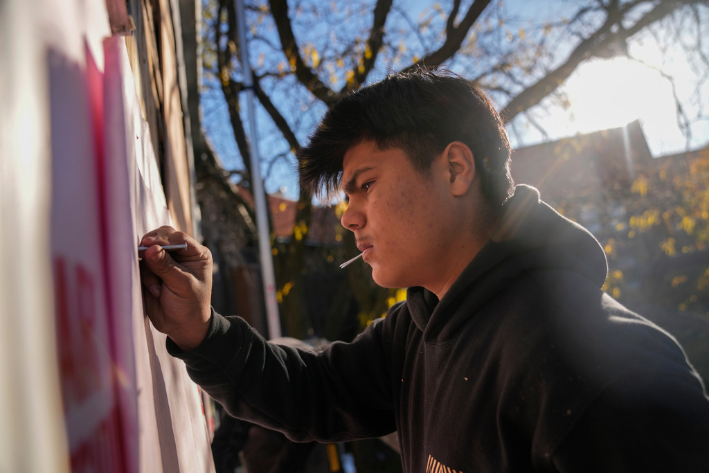 Uriel Villegas, who recorded cell phone video of the incident involving his older brother and as agents arrested two others in October, works at the construction site where his older brother was taken last month by federal immigration agents, Tuesday, Nov. 18, 2025, in Chicago. (AP Photo/Erin Hooley)