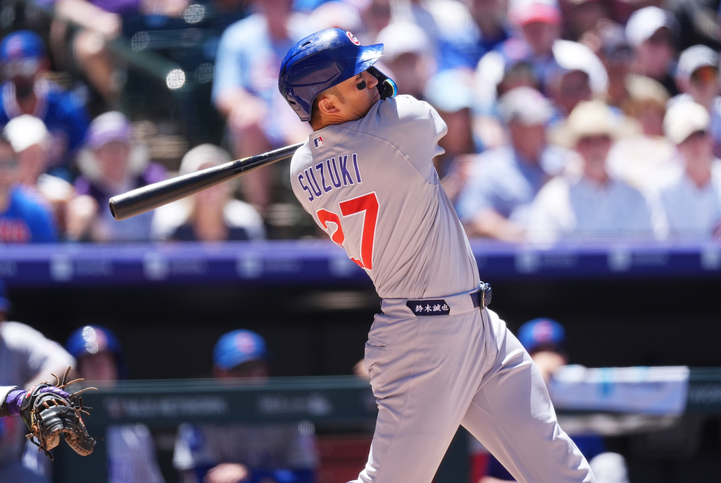 Chicago Cubs' Seiya Suzuki follows the flight of his grand slam off Colorado Rockies starting pitcher Ryan Feltner in the fourth inning of a baseball game Thursday, June 11, 2026, in Denver. (AP Photo/David Zalubowski)