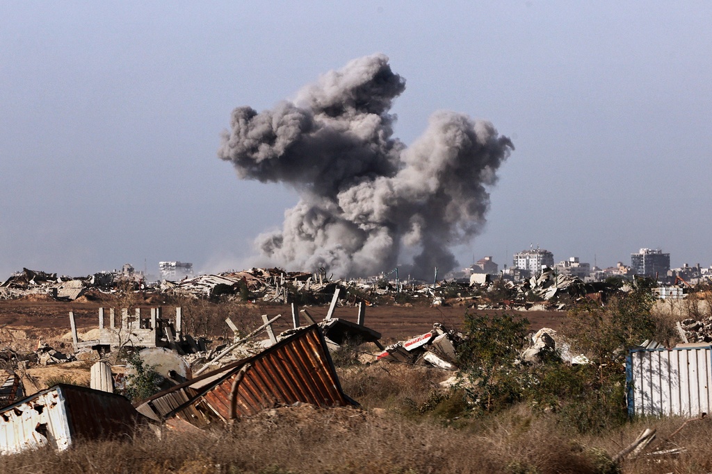 This picture taken during a media tour organised by the Israeli army shows a plume of smoke rising above Gaza City during an Israeli strike, Friday, Oct. 3, 2025. (Jack Guez/Pool Photo via AP)
