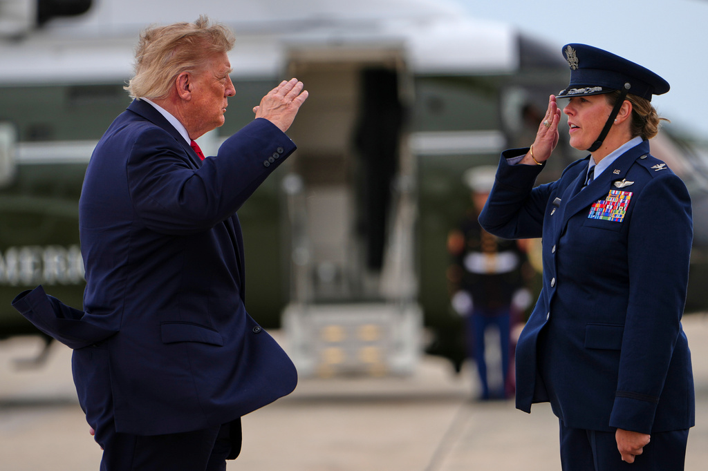 President Donald Trump, left, salutes as he walks from Marine One to board Air Force One, Saturday, Sept. 26, 2026, at Joint Base Andrews, Md. (AP Photo/Julia Demaree Nikhinson)