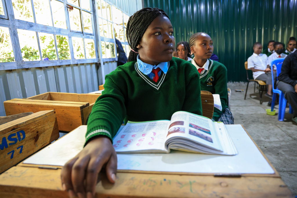Everlyne Nasenya,16, left, and Valarie Wairimu, 19, both teen mothers are seen in a classroom at Greenland Girls School in Kajiado, Kenya, March 5, 2026. (AP Photo/Andrew Kasuku)