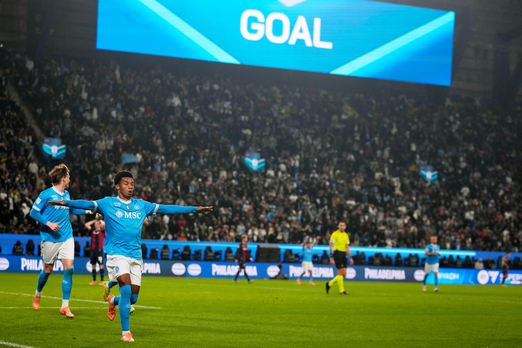 Napoli's David Neres, center, celebrates after scoring during the Italian Super Cup final soccer match between Napoli and Bologna in Riyadh, Saudi Arabia, Monday, Dec. 22, 2025. (AP Photo/Altaf Qadri)