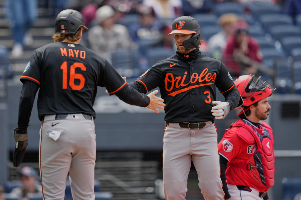 Baltimore Orioles' Taylor Ward (3) is congratulated at the plate by teammate Coby Mayo (16) in front of Cleveland Guardians catcher Austin Hedges, right, after hitting a three-run home run in the fiffth nning of a baseball game in Cleveland, Sunday, April 19, 2026. (AP Photo/Sue Ogrocki)