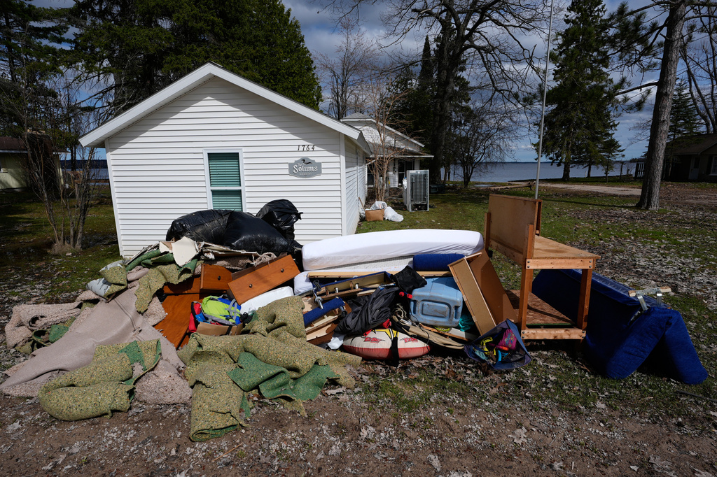 Damaged materials from the home of John Solum from recent floods at Black Lake sit outside on Wednesday, April 29, 2026, in Grant Township, Mich. (AP Photo/Paul Sancya)