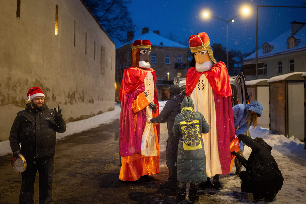 People prepare for a Three Kings parade during the Epiphany Day celebrations in Vilnius, Lithuania, Tuesday, Jan. 6, 2026. (AP Photo/Mindaugas Kulbis)