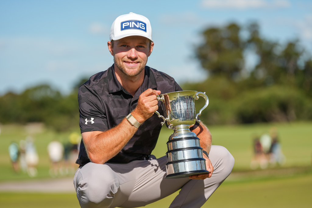 Denmark's Rasmus Neergaard-Petersen holds the Stonehaven Cup after winning the Australian Open golf tournament in Melbourne, Australia, Sunday, Dec. 7, 2025. (AP Photo/Asanka Brendon Ratnayake)