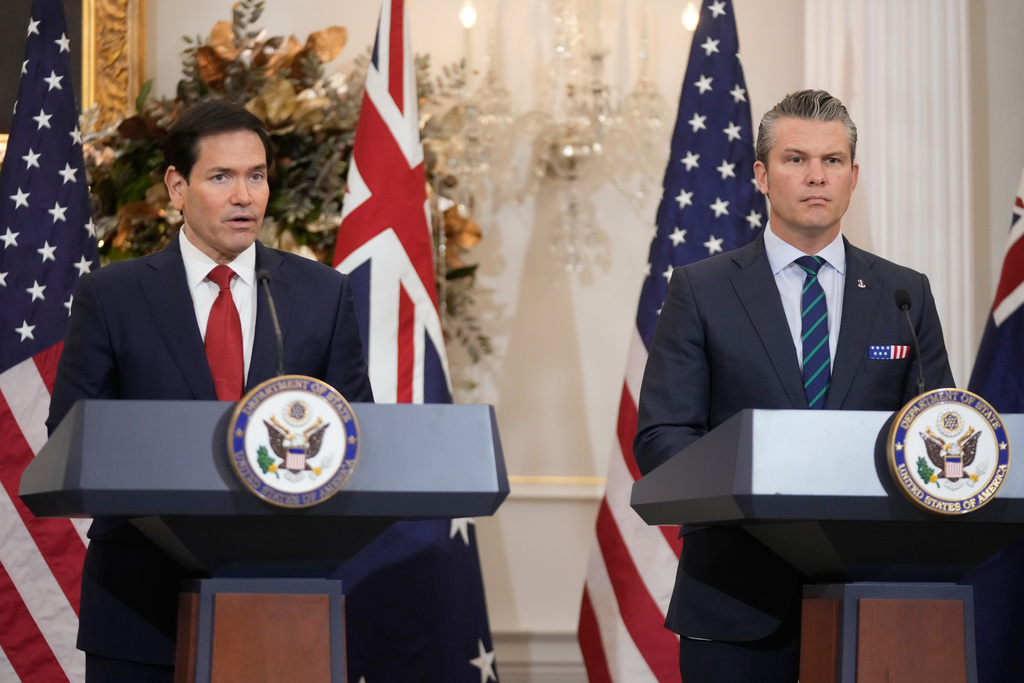 Secretary of State Marco Rubio speaks as Defense Secretary Pete Hegseth listens during a news conference with Australia's Deputy Prime Minister and Defense Minister Richard Marles and Australia's Foreign Minister Penny Wong at the State Department, Monday, Dec. 8, 2025, in Washington. (AP Photo/Mark Schiefelbein)
