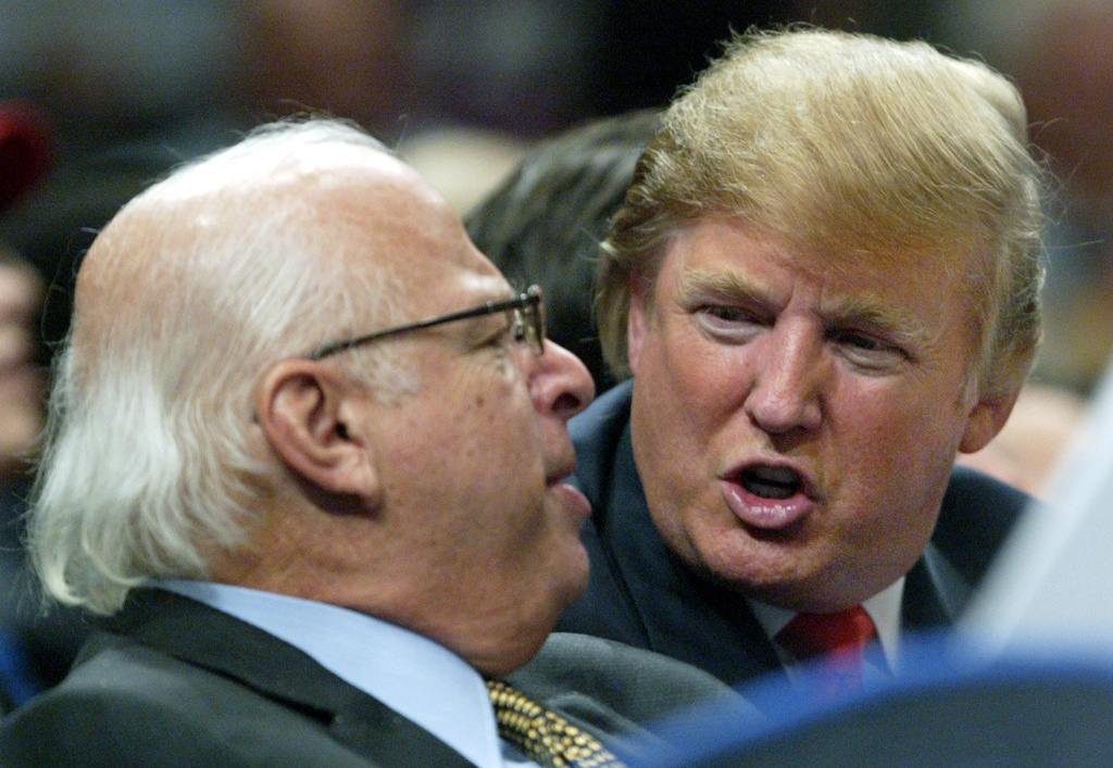 FILE - Donald Trump, right, talks to an unidentified man from the stands at Madison Square Garden during the New York Knicks game against the Dallas Mavericks on Jan. 11, 2006, in New York. (AP Photo/Kathy Willens, File)
