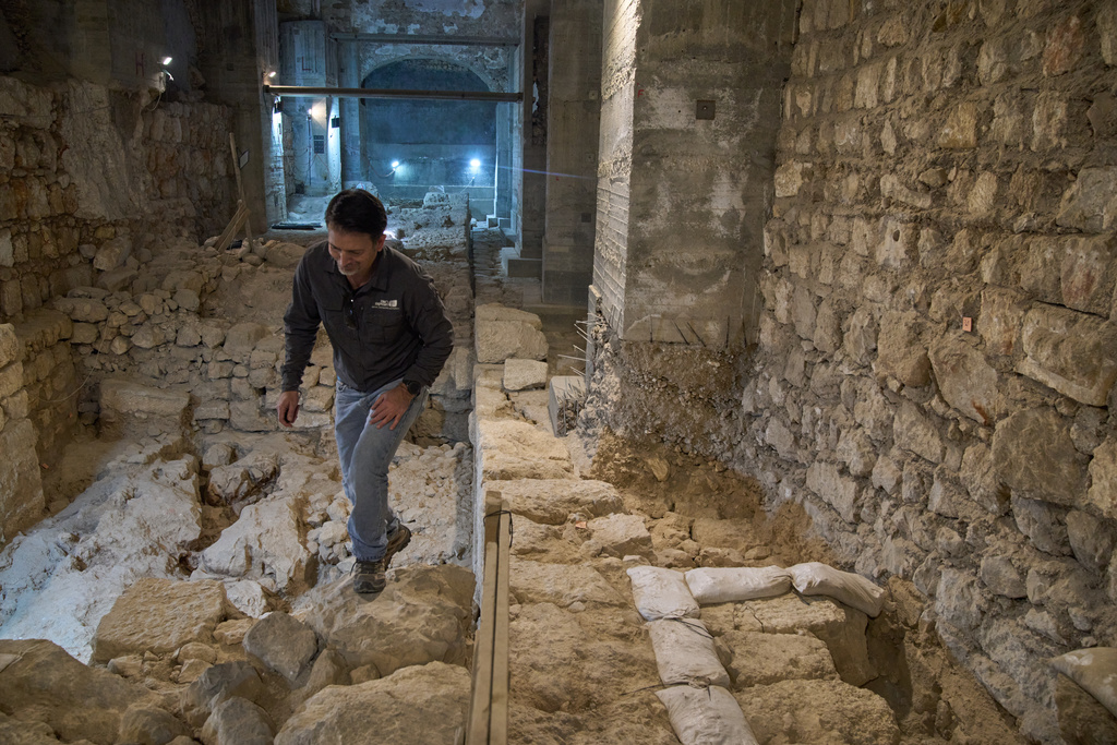 The Jerusalem Regional Archaeologist for the Israel Antiquities Authority, Dr. Amit Re'im, walks in a section of an excavation site where, according to the institution, a city wall from the Hasmonean period, dating to the late 2nd century BCE, was uncovered under the Tower of David Citadel Museum, in the Old City of Jerusalem, Monday, Dec. 8, 2025. (AP Photo/Leo Correa)