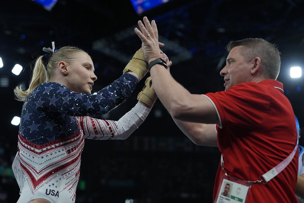 Jade Carey, of the United States, celebrates after performing on the vault during the women's artistic gymnastics team finals round at Bercy Arena at the 2024 Summer Olympics, Tuesday, July 30, 2024, in Paris, France. (AP Photo/Charlie Riedel)