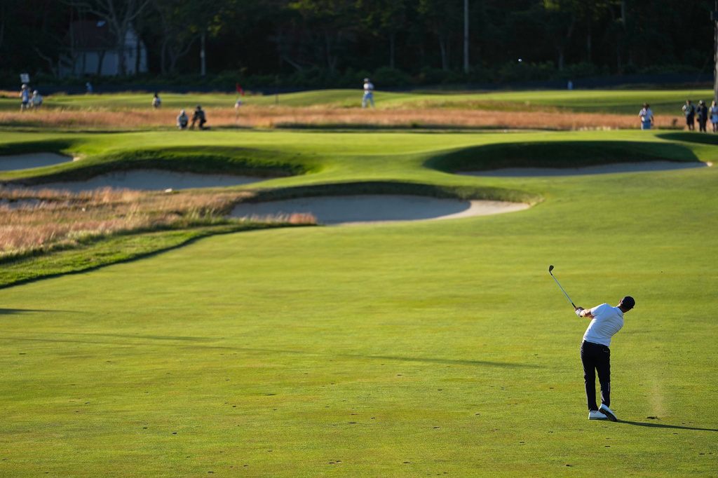 Wyndham Clark hits from the fairway on the 15th hole during the third round of the U.S. Open golf tournament at Shinnecock Hills Golf Club in Southampton, N.Y., Saturday, June 20, 2026.(AP Photo/George Walker IV)