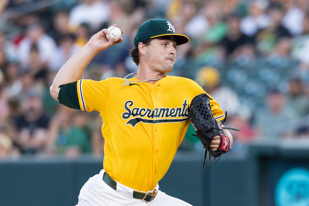 Athletics pitcher J.T. Ginn throws to the Texas Rangers during the third inning of a baseball game Saturday, Aug. 15, 2026, in West Sacramento, Calif. (AP Photo/Sara Nevis)