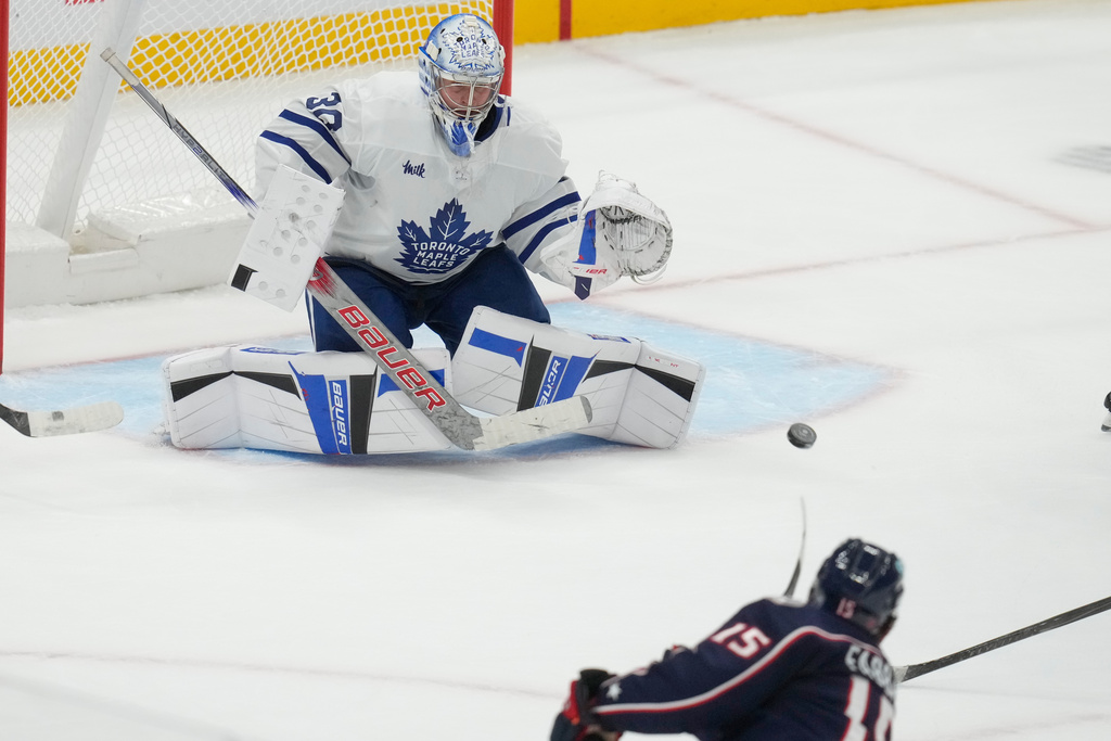 Columbus Blue Jackets defenseman Dante Fabbro (15) shoots and scores on Toronto Maple Leafs goaltender Cayden Primeau (30) in the second period of an NHL hockey game in Columbus, Wednesday, Oct. 29, 2025. (AP Photo/Sue Ogrocki)