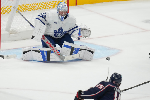 Columbus Blue Jackets defenseman Dante Fabbro (15) shoots and scores on Toronto Maple Leafs goaltender Cayden Primeau (30) in the second period of an NHL hockey game in Columbus, Wednesday, Oct. 29, 2025. (AP Photo/Sue Ogrocki) Columbus Blue Jackets defenseman Dante Fabbro (15) shoots and scores on Toronto Maple Leafs goaltender Cayden Primeau (30) in the second period of an NHL hockey game in Columbus, Wednesday, Oct. 29, 2025. (AP Photo/Sue Ogrocki)