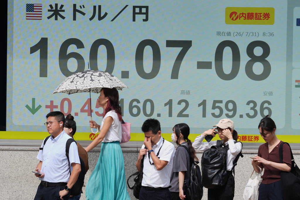 People stand in front of the electronic board showing Japanese Yen and U.S. Dollar exchange rate at a securities firm Friday, July 31, 2026. (AP Photo/Eugene Hoshiko)