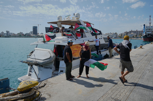 Activists stand in front of one of the Gaza-bound civilian flotilla Sumud's boats as it is docked at the port in Larnaca, Cyprus, on Friday, Oct. 3, 2025. (AP Photo/Petros Karadjias) Activists stand in front of one of the Gaza-bound civilian flotilla Sumud's boats as it is docked at the port in Larnaca, Cyprus, on Friday, Oct. 3, 2025. (AP Photo/Petros Karadjias)