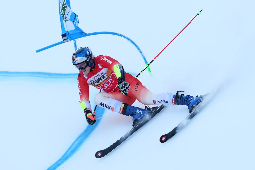 Switzerland's Marco Odermatt speeds down the course during an alpine ski, men's World Cup giant slalom, in Alta Badia, Italy, Sunday, Dec. 21,2025. (AP Photo/Alessandro Trovati)